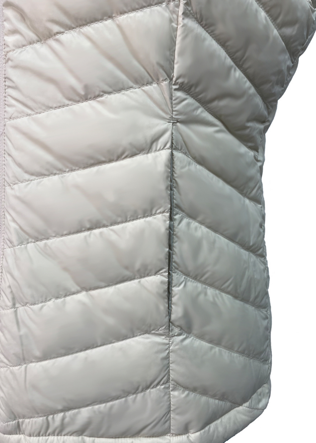 close up of the pocket of a white duck down puffer vest